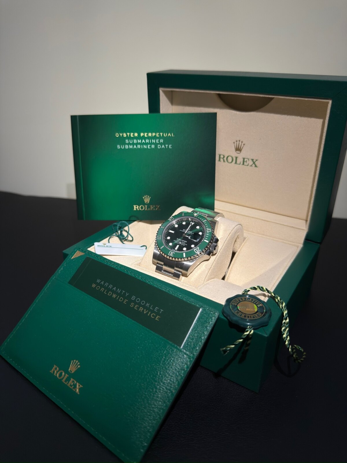 2017 Rolex Submariner Hulk 116610LV resting in original green Rolex presentation box with Warranty Booklet and Superlative Certified seal